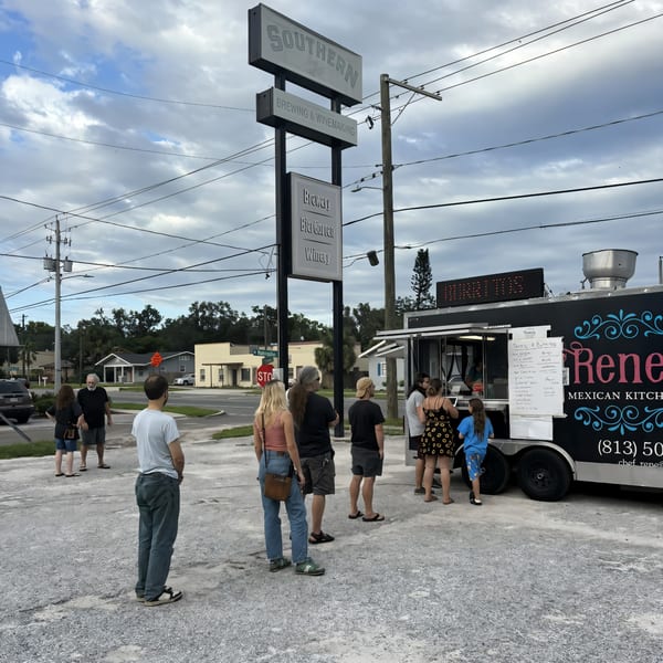 Customers queue at Rene's Mexican Kitchen food truck with a Southern Brewing & Winemaking sign nearby.