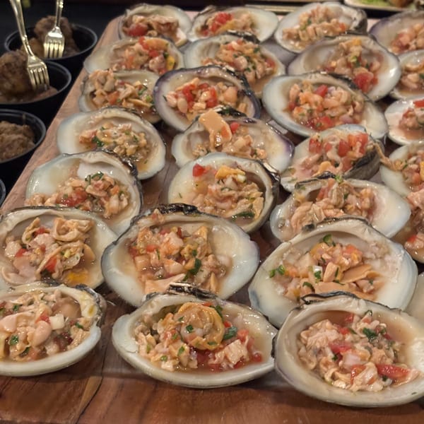 Numerous Rene's Mexican Kitchen clams on the half shell with pico de gallo and herbs.