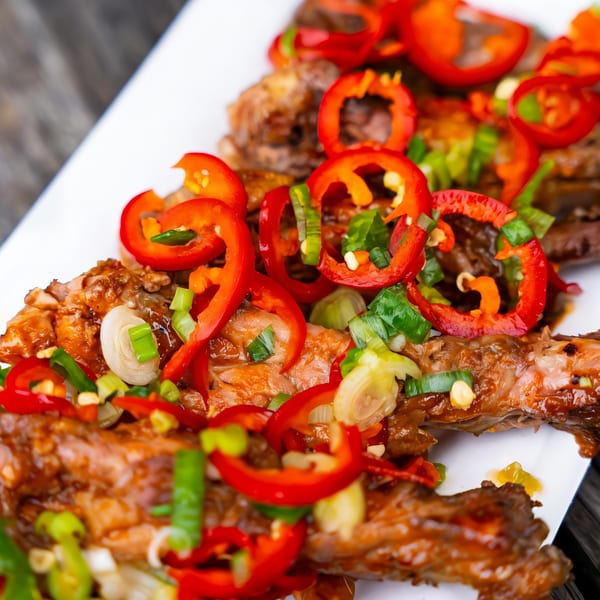 Close-up of Rene's Mexican Kitchen's chicken dish, garnished with red bell peppers and green onions.